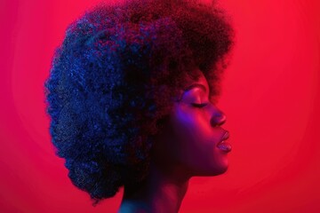 Young afro girl in wig poses for party photo.