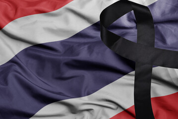 waving national flag of thailand with black mourning ribbon .tragedy concept