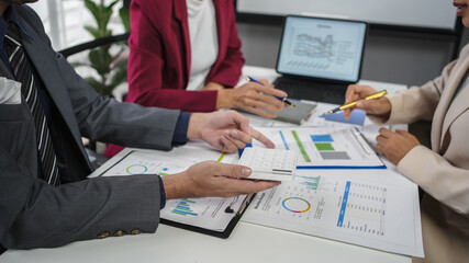 Business people are discussing together in meeting about the financial data documents at the modern office