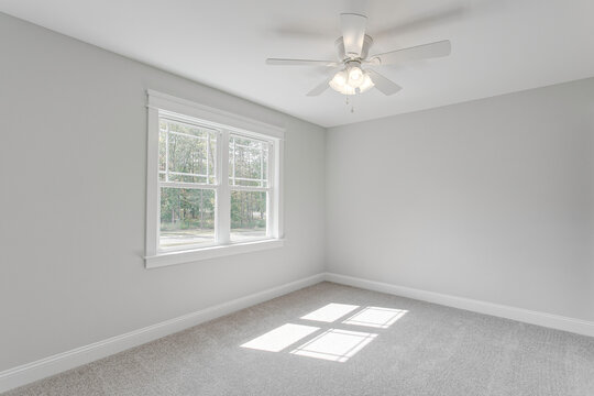 Minimal Bedroom With Carpet And Ceiling Fan Fixture