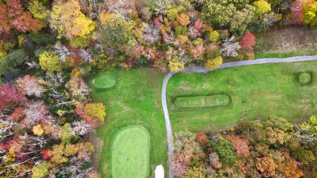 Drone footage of golf course and surrounding community with lake. 