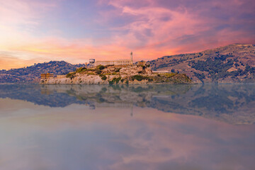 Alcatraz Island at sunset viewed from Fisherman's Wharf, offering a stunning and iconic view of San...