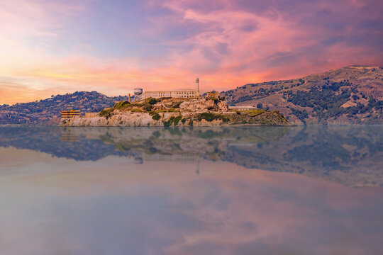 Alcatraz Island at sunset viewed from Fisherman's Wharf, offering a stunning and iconic view of San Francisco Bay.