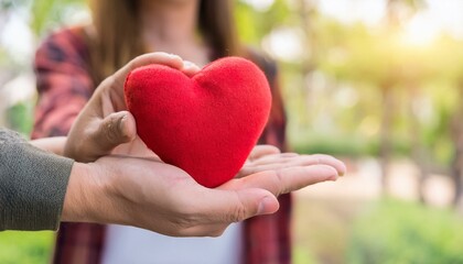 Woman Giving Heart On Man's Hand