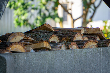 torn firewood lying on the plot, storing firewood behind the house