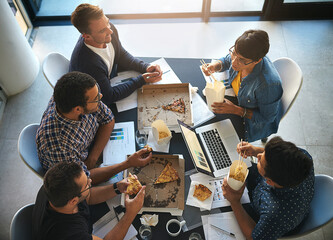 Creative, agency and business people in meeting with fast food, planning and collaboration from above. Eating, computer and team in workshop for development report, growth and data analysis in office