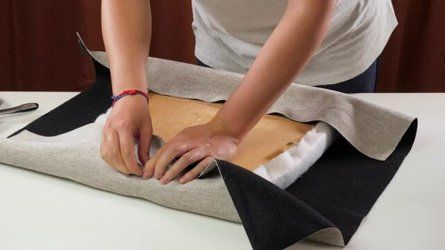 fixating upholstery fabric on chair seat with staple gun detail