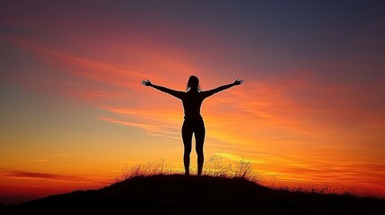 Silhouette of a person against a colorful sunset.