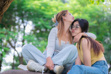 Naklejka premium Couple of girl with girl,LGBT Pride month concept,Asian Handsome male make up and wear woman cloth,Gay Freedom Day,Portrait of Non-binary on white background