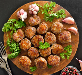 Roasted meatballs on cutting board
