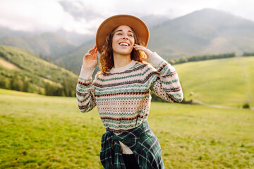 Happy Woman tourist admiring the landscape mountains nature. Beautiful mountains landscape.