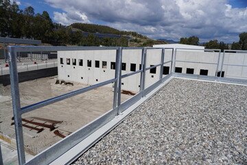 Industrial fence used as a roof parapet. Minimalist design with safety elements. Durability of...