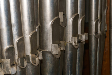 A large classical organ inside the Catholic Church.  A keyboard wind musical instrument. Pipe organ...