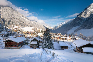 An Alpine village blanketed with snow from top to bottom.