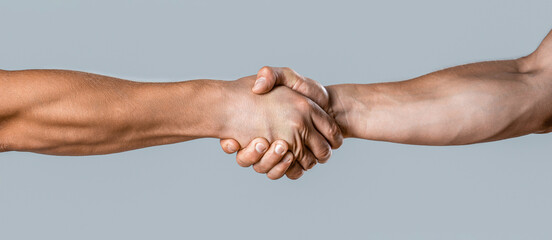 Friendly handshake, friends greeting, teamwork, friendship. Close-up. Rescue, helping gesture or...