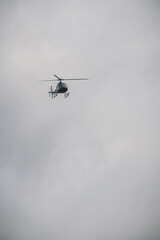 A helicopter is flying in the sky

