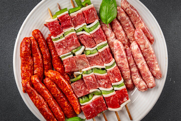 sausage meat assorted juicy pork, beef fresh delicious gourmet food background on the table rustick...