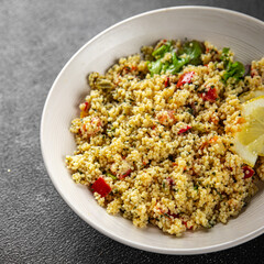 Tabbouleh bulgur couscous vegetables dish fresh vegetarian and vegan food gourmet food background...