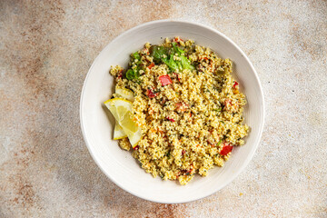 Tabbouleh bulgur couscous vegetables dish fresh vegetarian and vegan food gourmet food background on the table rustic food top view 