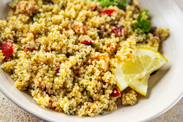 Tabbouleh bulgur couscous vegetables dish fresh vegetarian and vegan food gourmet food background on the table rustic food top view 