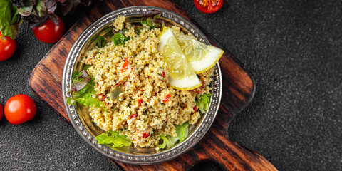 Tabbouleh bulgur couscous vegetables dish fresh vegetarian and vegan food gourmet food background...