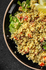 Tabbouleh bulgur couscous vegetables dish fresh vegetarian and vegan food gourmet food background...