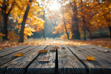 A wooden table that has fallen leaves on it