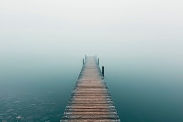 Fototapeta premium Wooden Dock Extending into Foggy Water