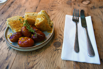 extravagant cuisine, restaurant small plate menu pork sausage and sour dough bread