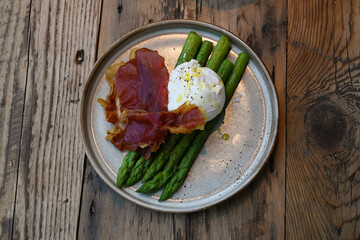 extravagant cuisine, Bacon and eggs on asparagus platter. small plate restaurant food 