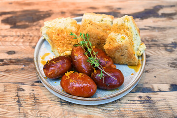 extravagant cuisine, restaurant small plate menu pork sausage and sour dough bread
