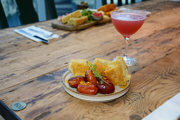 extravagant cuisine, restaurant small plate menu pork sausage and sour dough bread