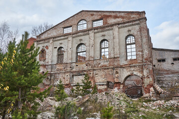 Fototapeta premium Abandoned destroyed brick building. Old facilities industrial premiums, Glass Factory area overgrowing with trees, Krasnoyarsk, Memory 13 Fighters.