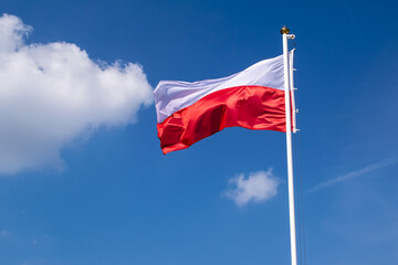 Polish flag against the sky