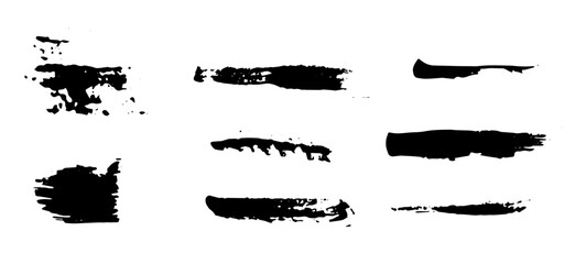 A set of black brushes or grunge style strokes.  Black silhouettes of grunge textures
