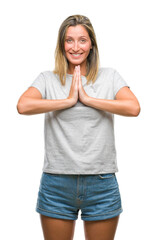 Young beautiful woman over isolated background praying with hands together asking for forgiveness smiling confident.