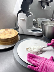 The process of making a cake at home. Honey cake. Layer the cakes with cream. Cooking desserts