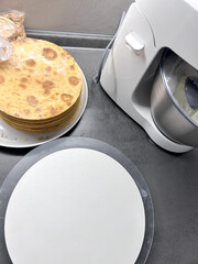 The process of making a cake at home. Honey cake. Layer the cakes with cream. Cooking desserts