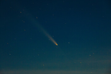 Comet Tsuchinshan-ATLAS shines brightly as it streaks across the night sky with a long glowing...