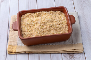 Farofa, typical brazilian manioc flour side dish over wooden table
