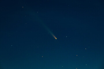 Comet Tsuchinshan-ATLAS shines brightly as it streaks across the night sky with a long glowing...