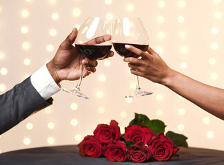Hands of black man and woman cheering at restaurant, celebrating Valentine's Day, close up