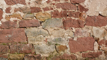 Ancient Stone Wall With a Mix of Red and Beige Stones in a Historic Area