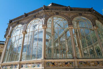 Detailed view of the Palacio de Cristal with glass and ornate columns in Madrid
