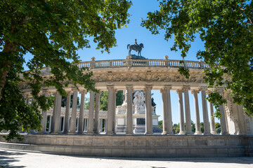 Monument to Alfonso XII in Retiro Park, Madrid surrounded by columns and trees