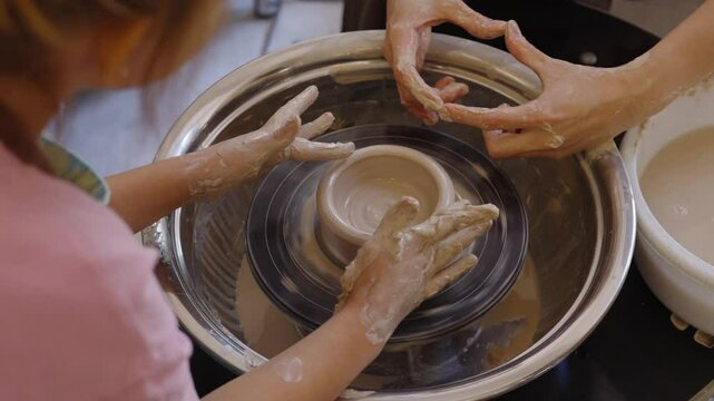 Creating pottery together at a local studio with a child, hands on experience