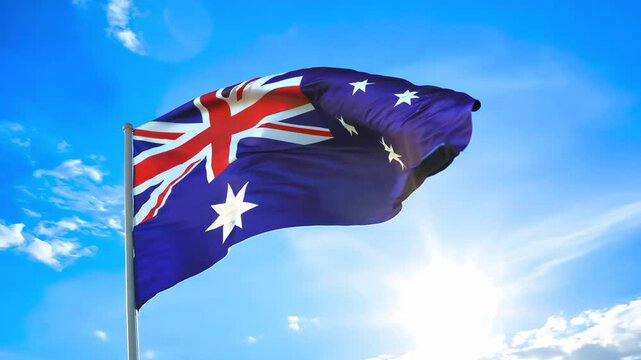 Australia flag waving against blue sky background. National celebration and anzac holiday concept. Democratic elections. Australian culture and history