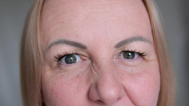 emotion through the eyes of a woman doubts squint slightly look at the camera