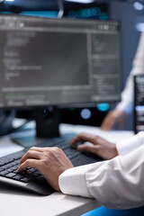 Admin in data center checking equipment performance on computer after upgrading infrastructure....
