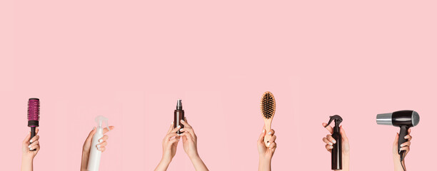 Collage with female hands holding different hair care products and equipment over pink background, copy space. Panorama